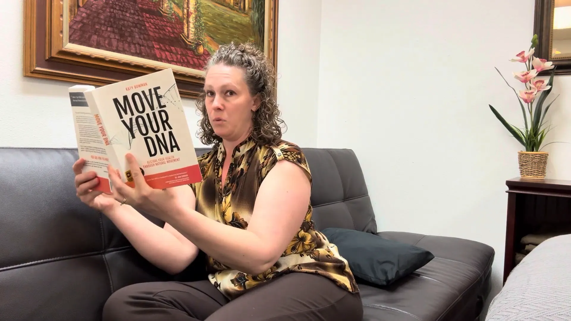 Holding book up to eye level while sitting with support