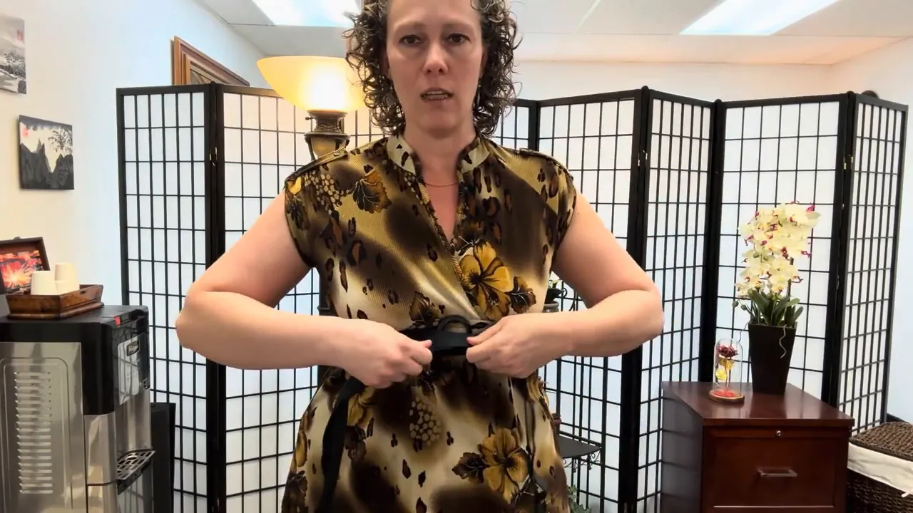 Demonstration of wrapping a strap around the waist for breathing feedback