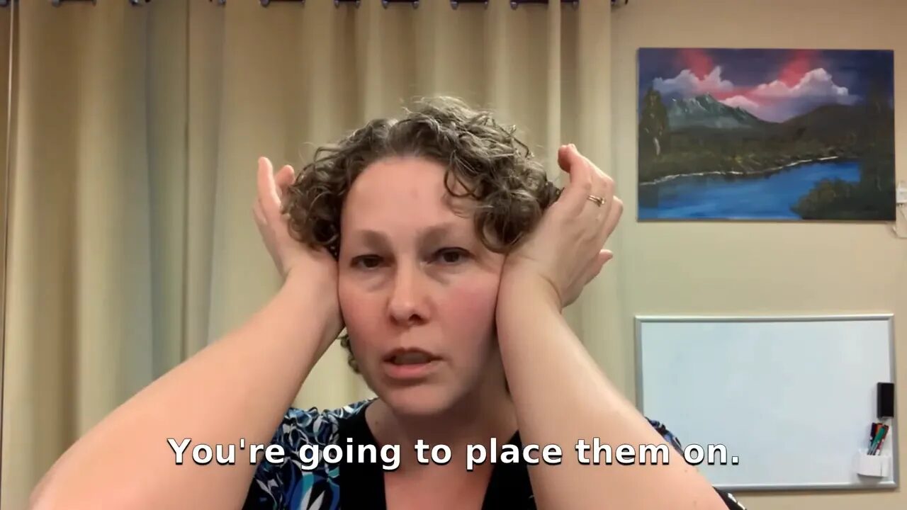 Person placing the heels of both hands at the sides of their head near the temples